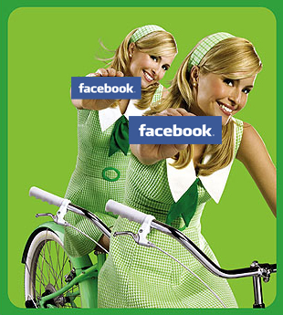 twins riding a bike holding up facebook banners