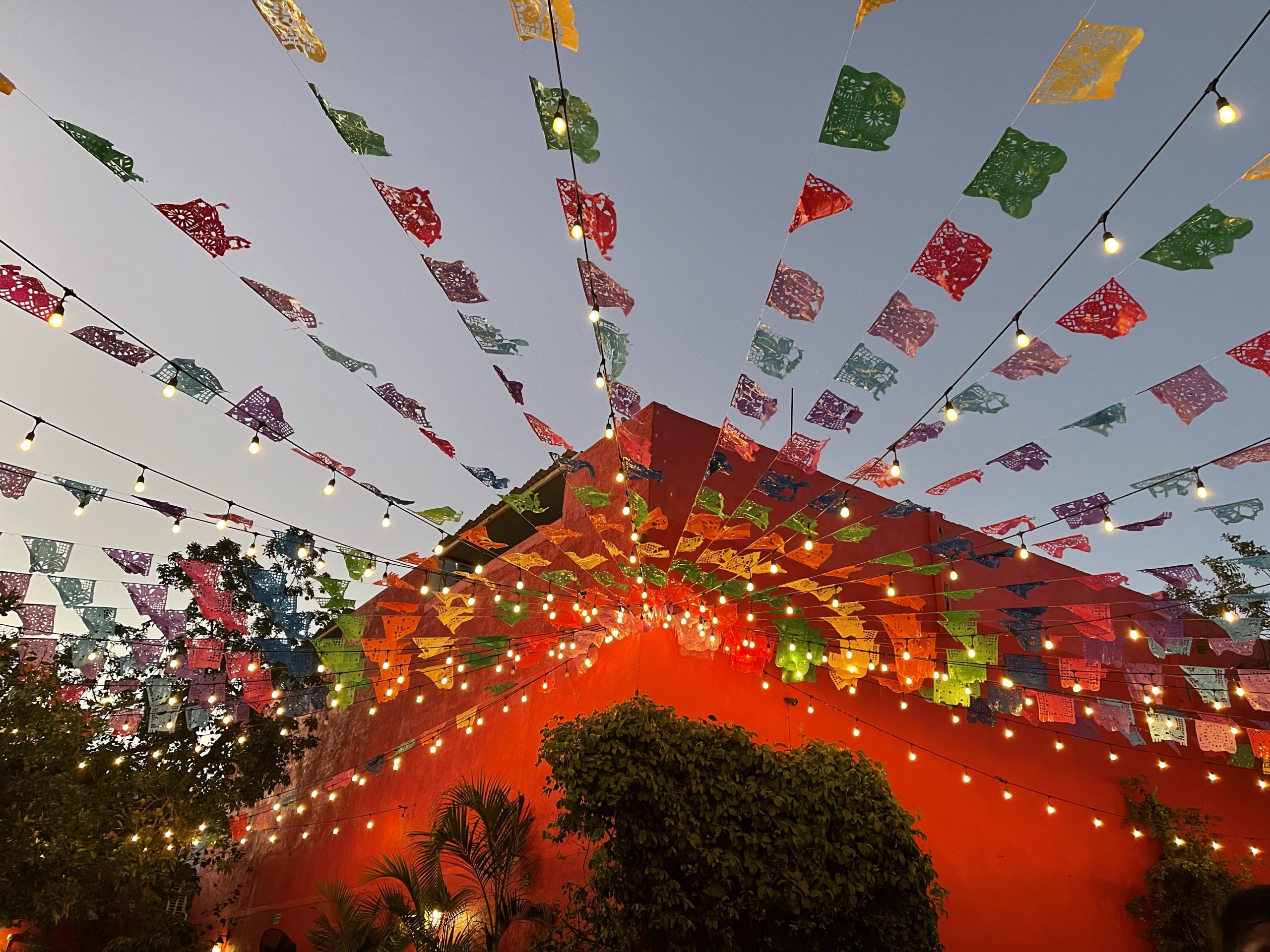 flags waving at red building at los tres gallos in cabo san lucas mexico