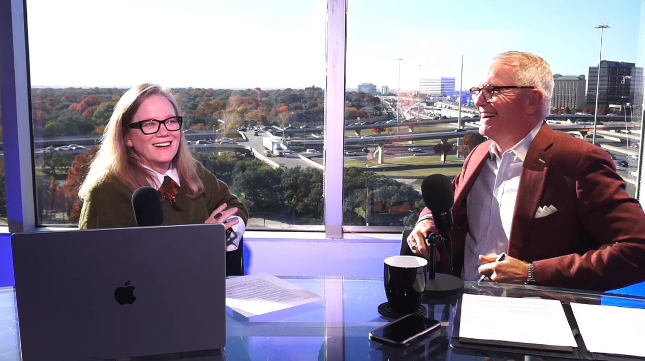 Two people discussing in a studio. Marc Miller and Sandy Hibbard on the set of the Insiders.